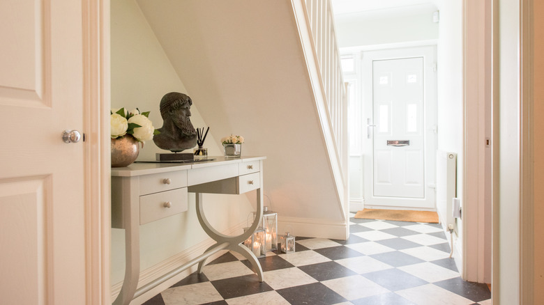Black and white checkerboard flooring in a hallway