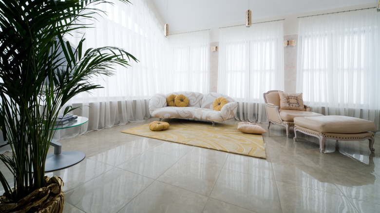 A high-gloss tile flooring in a living room with cream-colored furnishings