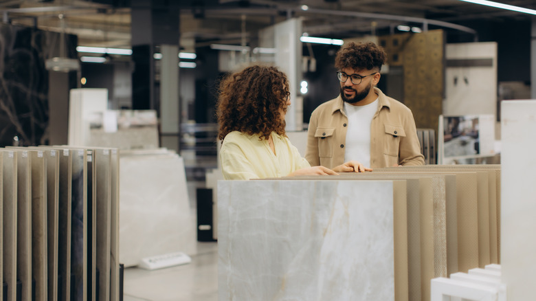 A young couple is looking at tile options in a store