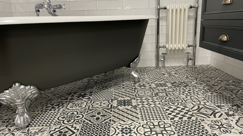 Small black and white patterned tiles on a bathroom floor
