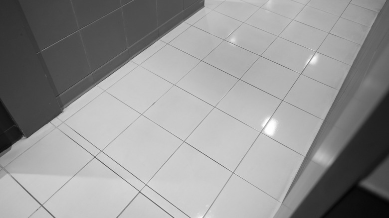 Plain white floor tiles laid out in a grid format