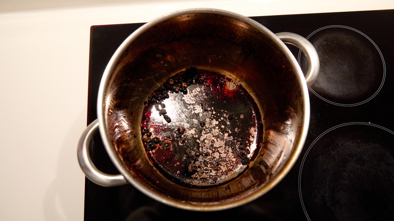 Inside a dirty pot covered in black stains