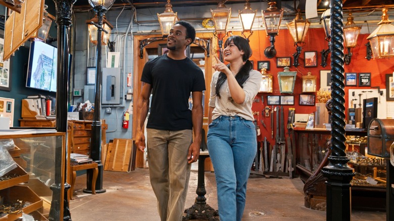 Couple looking around at vintage decor in thrift store