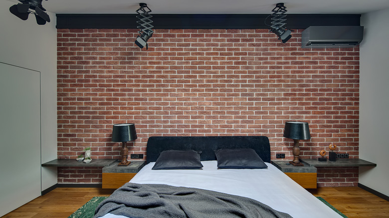 A cozy living room with an exposed brick wall.