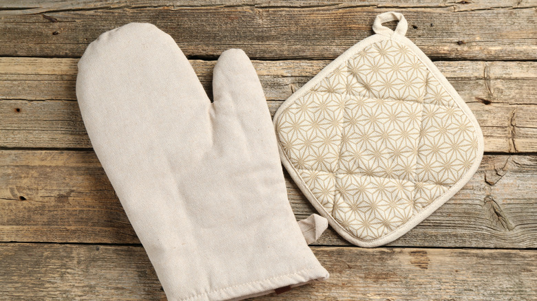 Light gray oven mitt and potholder on a table