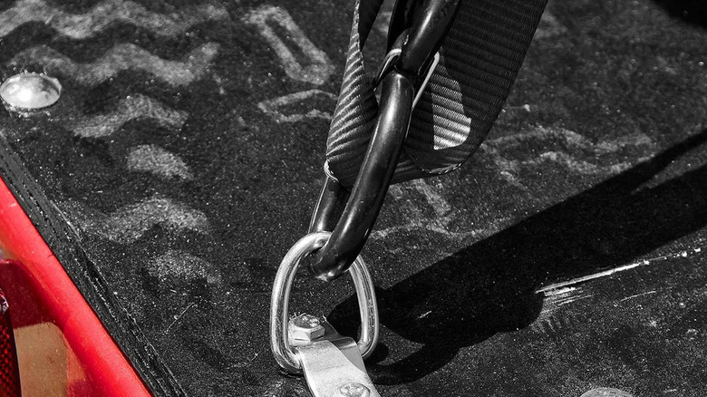 A strap attached to a trailer D-ring