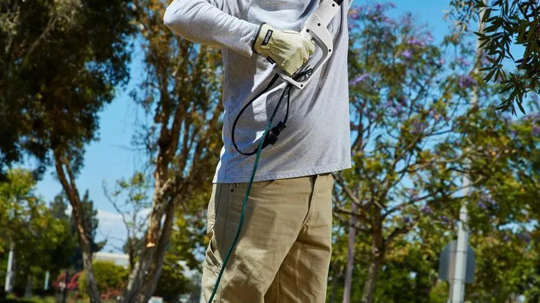 An extension cord attached to tree-care equipment