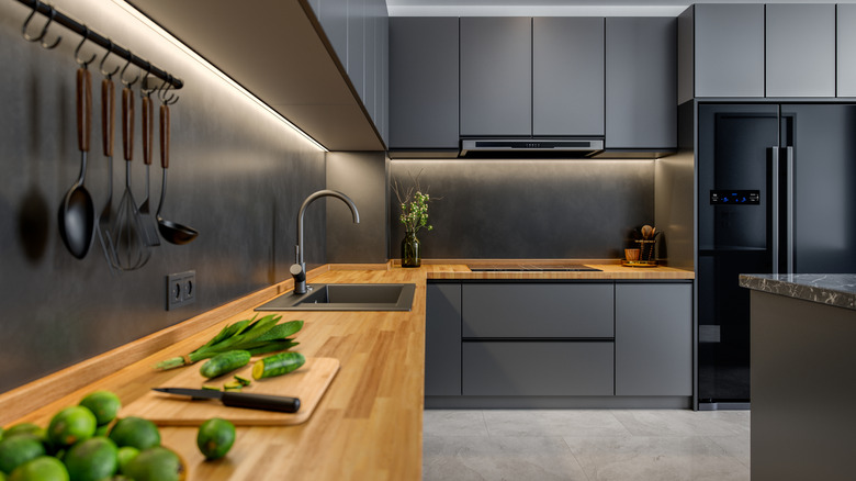 A kitchen with various dark-colored surfaces