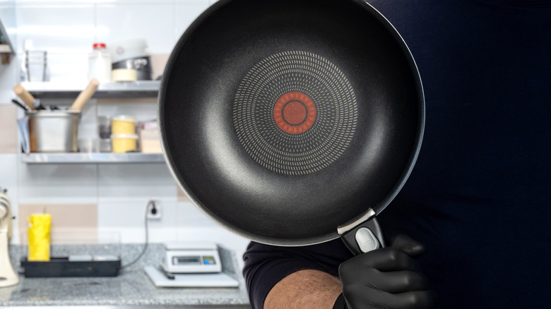 Man holding a non-stick pan