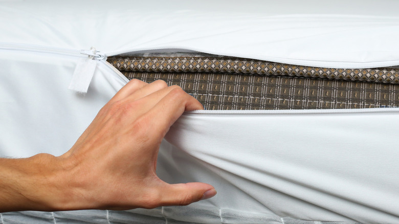 Person unzipping cushion cover