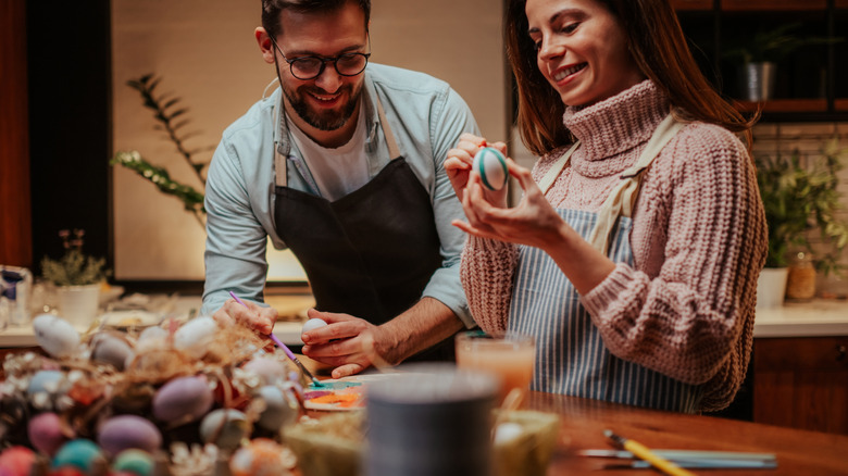 Easter eggs and art supplies used at a dining table