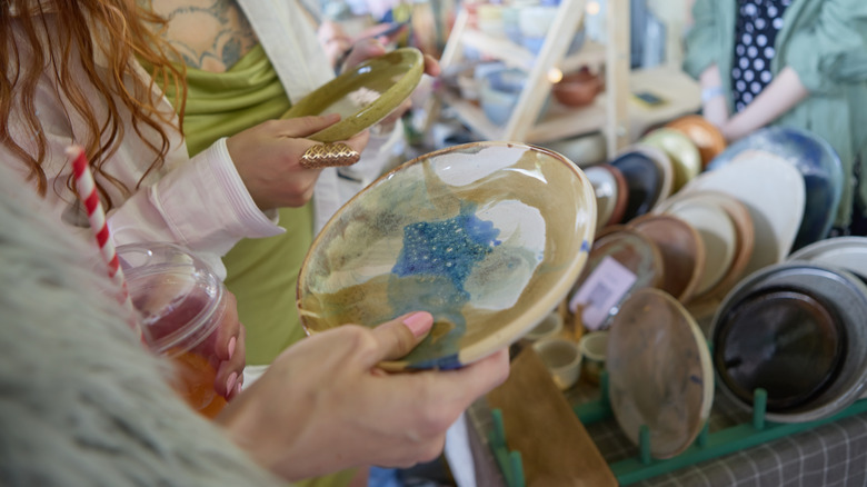 Couple shopping for antique pottery