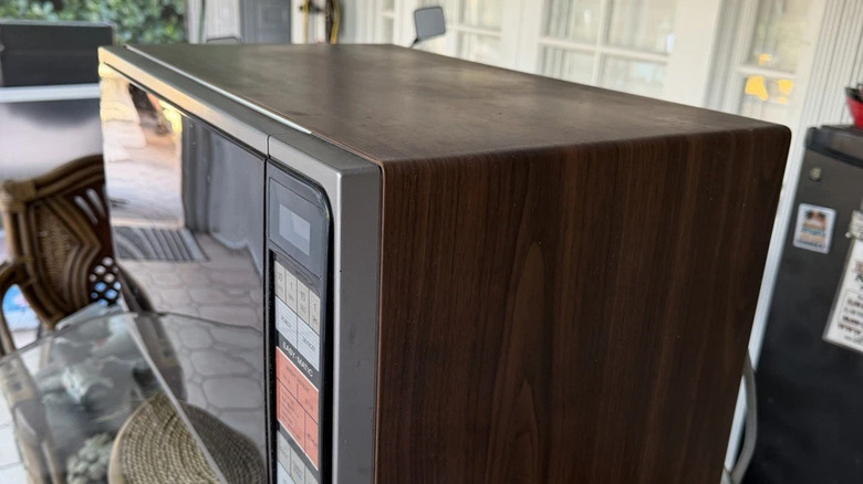 A Quasar Easy-Matic countertop microwave with woodgrain finish