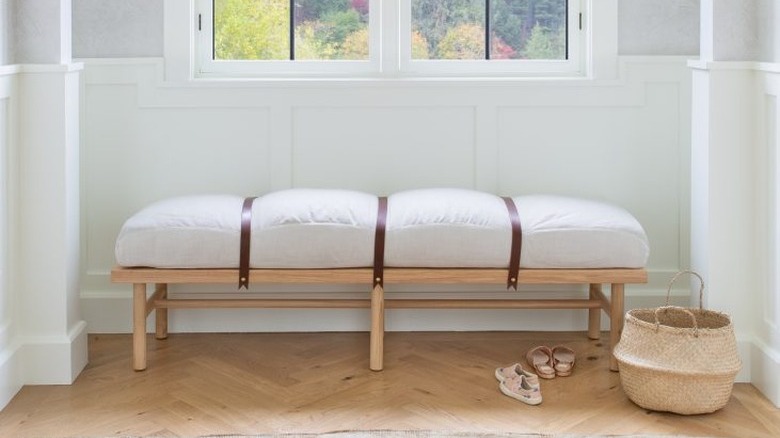 white hallway with simple window bench under a window