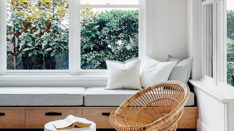 white sunroom with minimalist window bench with built-in drawers