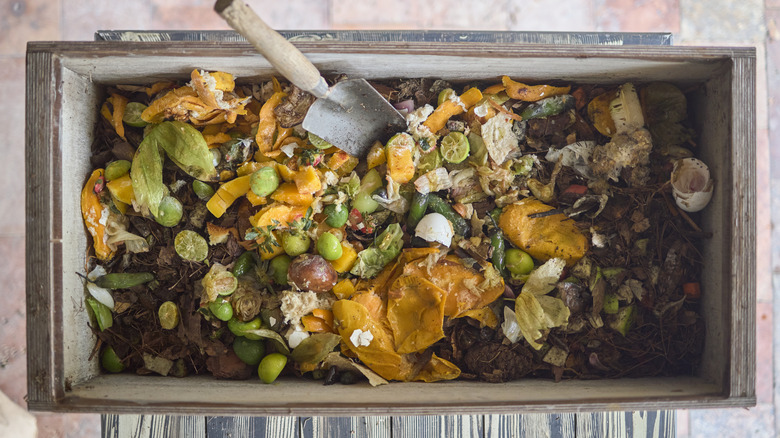 Wooden bin full of compost seen from above