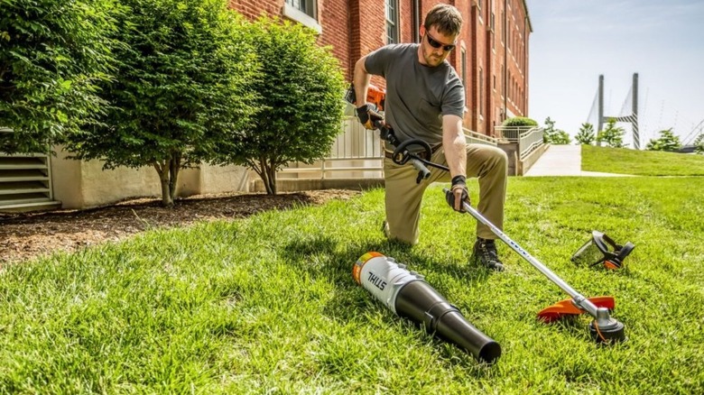 Man using the Stihl weed eater on his lawn