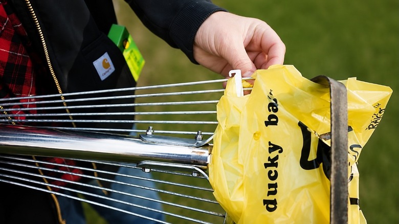 Picking up waste with the Rak-O multi-purpose garden tool