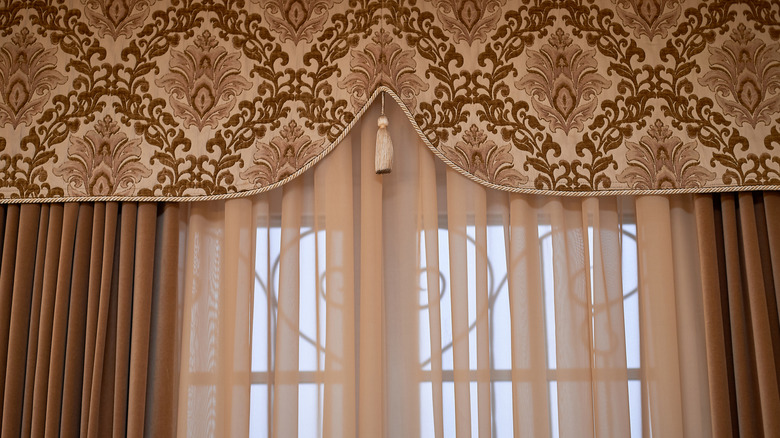 A close up of brown curtain with valence
