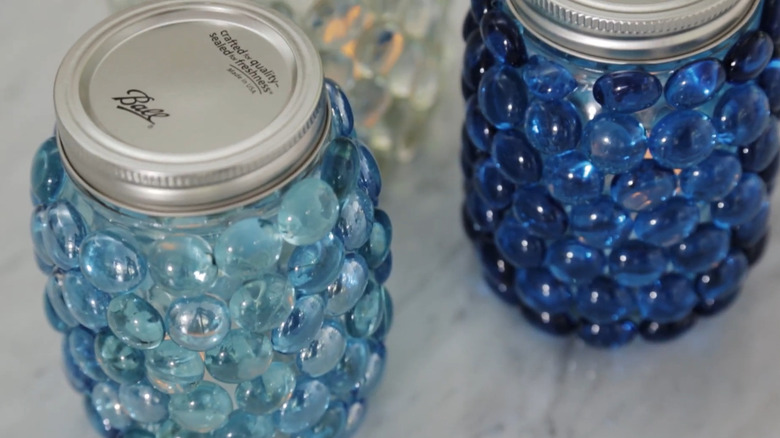Mason jars covered in flat glass gemstones with battery-powered tea lights inside