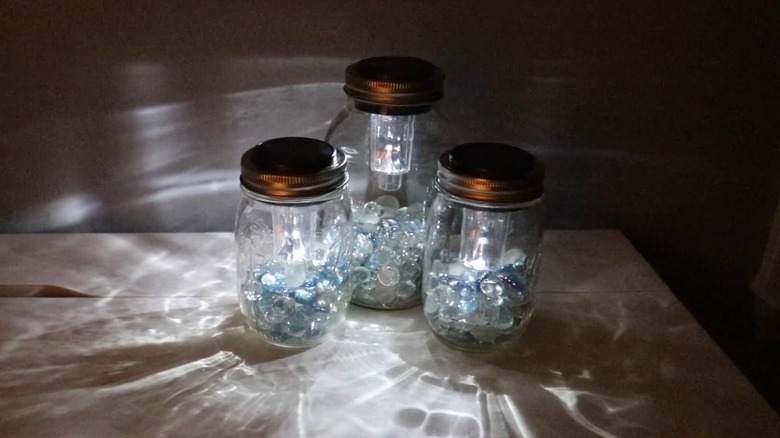 Mason jars with glass beads inside and a solar light in the top