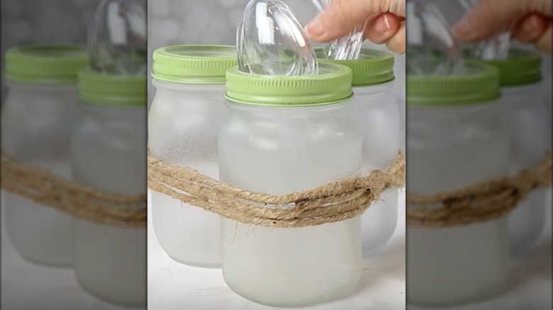 Three Mason jars glued together to create a plastic silverware caddy