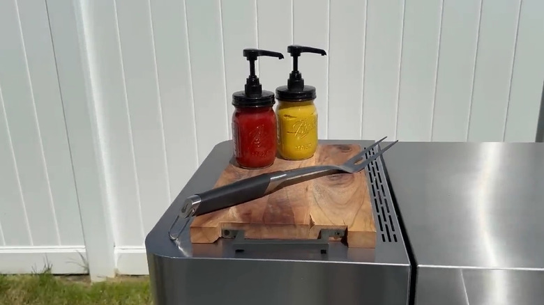 Ketchup and mustard in Mason jar pump dispensers
