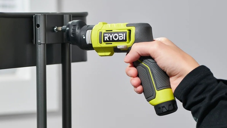 Person using Ryobi USB Lithium Multi-Head Screwdriver to build storage cart