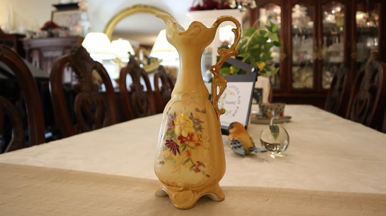 Porcelain vase with gold gilt and painted flowers