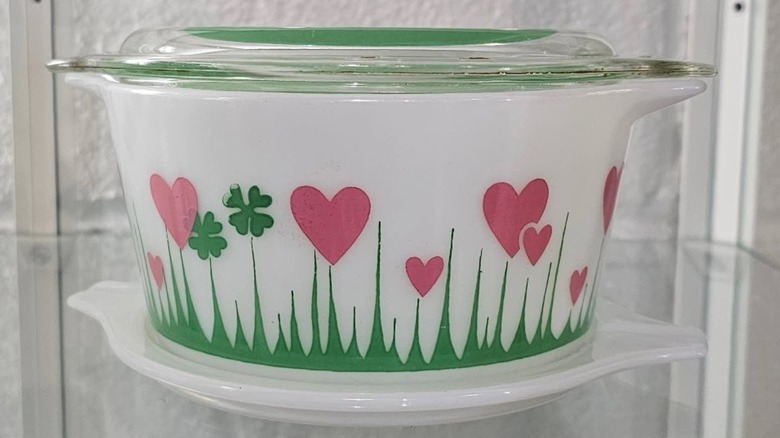 a Pyrex Lucky In Love Casserole Dish sits on a glass shelf
