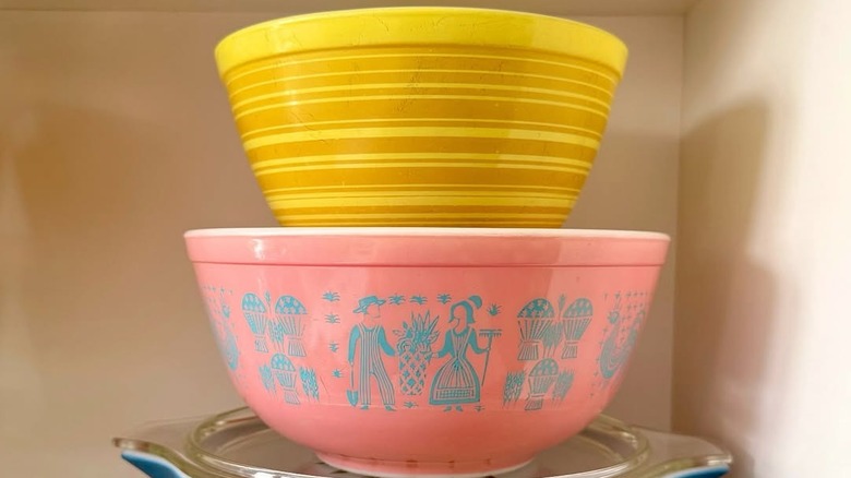 a Pyrex Terra 402 Yellow Stripe Mixing Bowl stacked on a pink mixing bowl