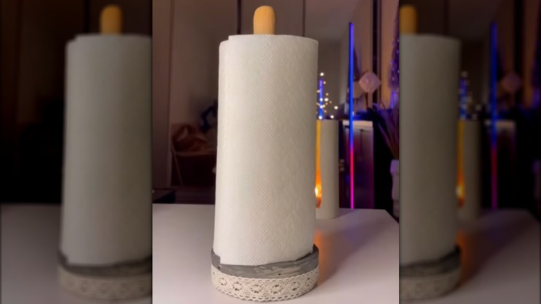 DIY paper towel holder made with a concrete base and a wooden dowel