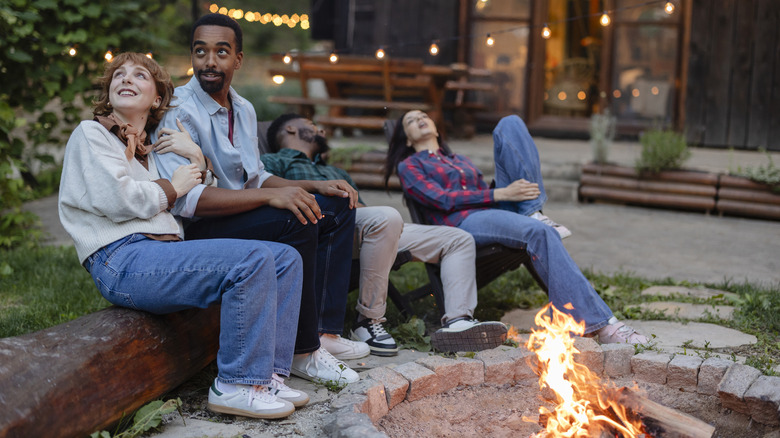 Friends enjoying a night around a homemade firepit