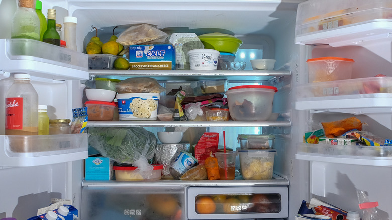 disorganized fridge full of food