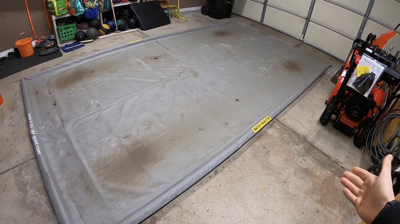 Man presenting alternative method for garage floor protection