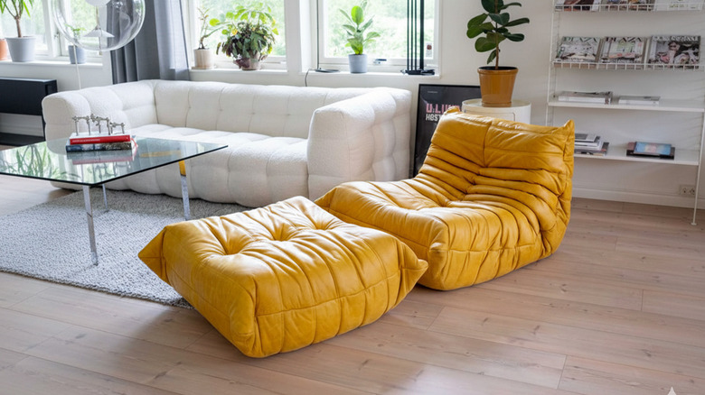 living room with a replica of a yellow leather Togo chair and ottoman