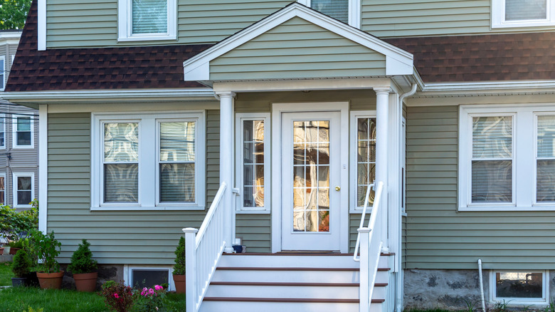 Classic two-story American home with white glass door and matching windows