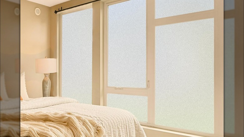 Privacy film over glass in a bedroom letting light in while blocking the view