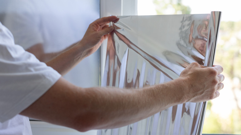 Closeup of man installing window film