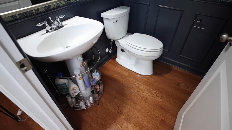 Pedestal sink with wire organizer and hooks with various bathroom products