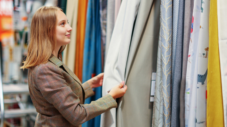 Woman shopping for curtains in a store