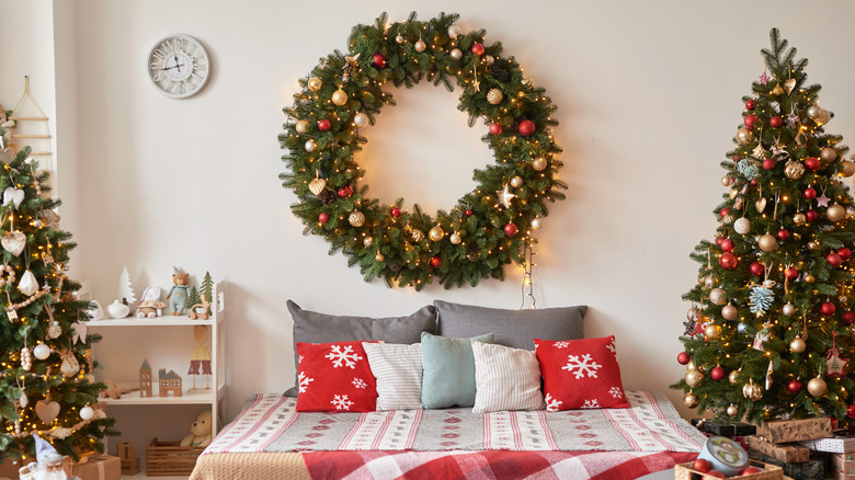 a bedroom with a Christmas tree and decorations