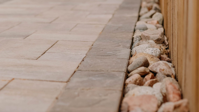 A paver driveway with a gravel border