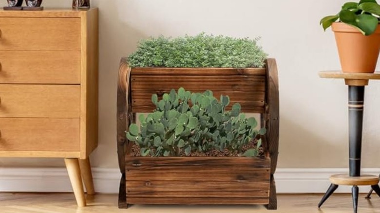 Wagon wheel planter box with plants inside placed in home