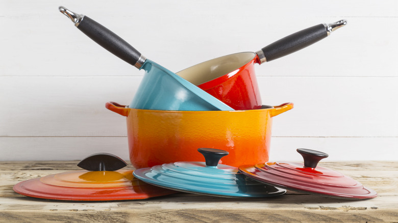Colorful Le Creuset saucepans with lids