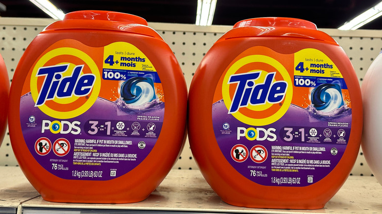 Bright orange Tide pod containers on a retail shelf.