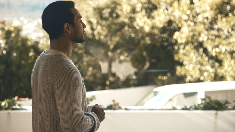 A man gazes out at his driveway