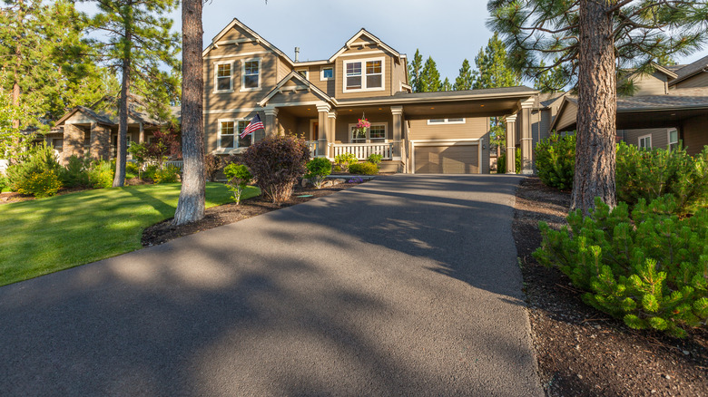 Large house with an asphalt driveway.