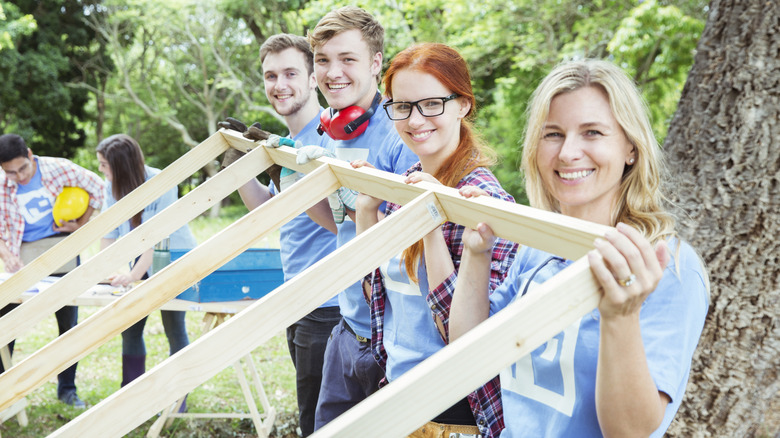 Friends and neighbors raising a wall