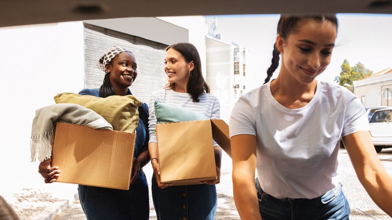 Neighbors helping others unpack from moving